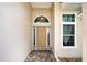 Attractive front door with sidelights and decorative trim at 1216 Whitney Dr, Venice, FL 34293