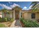 Eye-catching front entrance with a classic-style door and professionally landscaped garden at 1216 Whitney Dr, Venice, FL 34293
