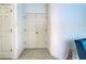 Hallway featuring a closet with double doors and neutral-colored tile flooring at 1216 Whitney Dr, Venice, FL 34293