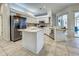 Bright kitchen featuring stainless steel appliances, tiled floors, and a center island at 1216 Whitney Dr, Venice, FL 34293