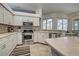 Bright kitchen showcasing stainless steel appliances, tile backsplash, and ample counter space at 1216 Whitney Dr, Venice, FL 34293