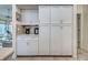 Pantry with pull out wooden shelves for organized and easy accessibility at 1216 Whitney Dr, Venice, FL 34293