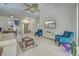 Open-concept living room with tile flooring, a ceiling fan, and plenty of natural light at 1216 Whitney Dr, Venice, FL 34293