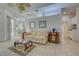 Comfortable living room with tile floors, a ceiling fan, and plenty of natural light at 1216 Whitney Dr, Venice, FL 34293