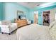 The main bedroom features tile floors, turquoise walls, and a walk-in closet at 1216 Whitney Dr, Venice, FL 34293