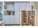 Pull out wooden shelves in pantry make for easy access and organized space at 1216 Whitney Dr, Venice, FL 34293