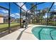 Screened-in pool area with a grill, and a view of the beautiful pond and community at 1216 Whitney Dr, Venice, FL 34293