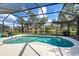 Beautiful screened-in pool with views of a pond and neighboring homes at 1216 Whitney Dr, Venice, FL 34293