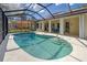 An inviting pool with a screened enclosure and an outside dining area at 1216 Whitney Dr, Venice, FL 34293