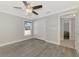 Well-lit bedroom with wood-look floors and double doors at 1312 Wasilla St, North Port, FL 34291