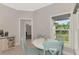 Charming breakfast nook with a round table and four light teal chairs at 1312 Wasilla St, North Port, FL 34291