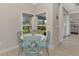 Bright breakfast nook features a round table and four light teal chairs at 1312 Wasilla St, North Port, FL 34291