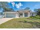 Newly constructed one-story home with attached garage and landscaped yard at 1312 Wasilla St, North Port, FL 34291