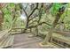 Wooden deck overlooking a tranquil waterway in a lush park setting at 1312 Wasilla St, North Port, FL 34291