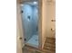 Modern shower with marble-look tile and glass enclosure at 1449 Deer Creek Dr, Englewood, FL 34223