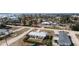 Aerial view of a quaint neighborhood with waterfront access and homes with boat parking, near tropical trees and landscaping at 1455 New Point Comfort Rd, Englewood, FL 34223