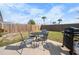 Outdoor patio with grill, seating in a fenced backyard, and green lawn at 1455 New Point Comfort Rd, Englewood, FL 34223
