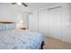 Bright bedroom with tile flooring, ceiling fan, and a closet with sliding doors at 1455 New Point Comfort Rd, Englewood, FL 34223
