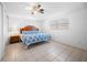 Spacious bedroom with tile floors, ceiling fan, and natural light from multiple windows at 1455 New Point Comfort Rd, Englewood, FL 34223