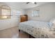 Sunny bedroom with tile flooring, a large window, and a dresser at 1455 New Point Comfort Rd, Englewood, FL 34223