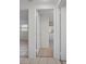 Hallway view showing tiled floors and access to various rooms of the house at 1455 New Point Comfort Rd, Englewood, FL 34223