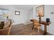 Comfortable living room showcasing wood-look floors, natural light, and a stylish writing desk area at 1455 New Point Comfort Rd, Englewood, FL 34223