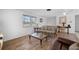 Cozy living room featuring wood-look floors, bright natural light, and comfortable seating at 1455 New Point Comfort Rd, Englewood, FL 34223
