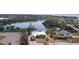 Aerial view of the home next to a scenic pond, showing the property's unique location and outdoor appeal at 1493 New Point Comfort Rd, Englewood, FL 34223
