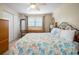 Comfortable bedroom with a ceiling fan, large bed, and closet at 1493 New Point Comfort Rd, Englewood, FL 34223
