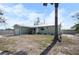 Charming single-story home features a metal roof, covered porch, attached garage and convenient storage shed at 1493 New Point Comfort Rd, Englewood, FL 34223