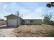 Exterior view of the light green home with an attached garage at 1493 New Point Comfort Rd, Englewood, FL 34223