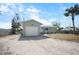 Exterior showcasing the home, detached garage, and spacious yard at 1493 New Point Comfort Rd, Englewood, FL 34223