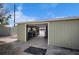 View into the shed with an open garage door showcasing the water view and the organized interior at 1493 New Point Comfort Rd, Englewood, FL 34223