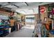 Interior shot of the garage featuring organized storage, fishing equipment, and a water view at 1493 New Point Comfort Rd, Englewood, FL 34223