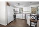 Bright kitchen features white cabinets, stainless steel appliances, granite countertops and wood floors at 1493 New Point Comfort Rd, Englewood, FL 34223