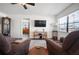 Bright living room with lots of natural light, a ceiling fan and view into another room at 1493 New Point Comfort Rd, Englewood, FL 34223