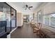 Light-filled sunroom with tile flooring, windows and access to other rooms at 1493 New Point Comfort Rd, Englewood, FL 34223