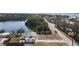 Scenic aerial view of home with a nearby pond and partial views of the neighborhood and surrounding streets at 1495 New Point Comfort Rd, Englewood, FL 34223
