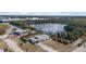 Scenic aerial view of a home with a nearby pond surrounded by lush greenery and mature trees at 1495 New Point Comfort Rd, Englewood, FL 34223