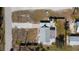 An aerial perspective showcasing the home's roof and layout, highlighting the property's dimensions and surrounding landscape at 1495 New Point Comfort Rd, Englewood, FL 34223