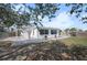 Backyard with patio, shed, and a view of surrounding foliage at 1495 New Point Comfort Rd, Englewood, FL 34223