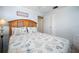 Inviting bedroom with wood headboard, shell patterned bedding, and a glass side table at 1495 New Point Comfort Rd, Englewood, FL 34223