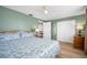 Light-filled bedroom with closet, ensuite, and laminate floors at 1495 New Point Comfort Rd, Englewood, FL 34223