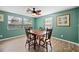 Charming dining room with hardwood floors, a wood table, and lots of natural light at 1495 New Point Comfort Rd, Englewood, FL 34223