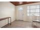 A simple entryway with wood ceiling, tile floors, and white walls at 1495 New Point Comfort Rd, Englewood, FL 34223
