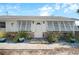 A home with an inviting front entrance with stone accents and shuttered windows at 1495 New Point Comfort Rd, Englewood, FL 34223