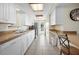 Galley kitchen with white cabinets and stainless steel appliances at 1495 New Point Comfort Rd, Englewood, FL 34223