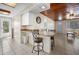 Bright kitchen with breakfast bar, white cabinetry, and tile floors at 1495 New Point Comfort Rd, Englewood, FL 34223