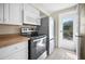 Kitchen appliances and door to outside at 1495 New Point Comfort Rd, Englewood, FL 34223