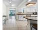 Spacious kitchen with white cabinets, tile floors, and an island with barstool seating at 1495 New Point Comfort Rd, Englewood, FL 34223